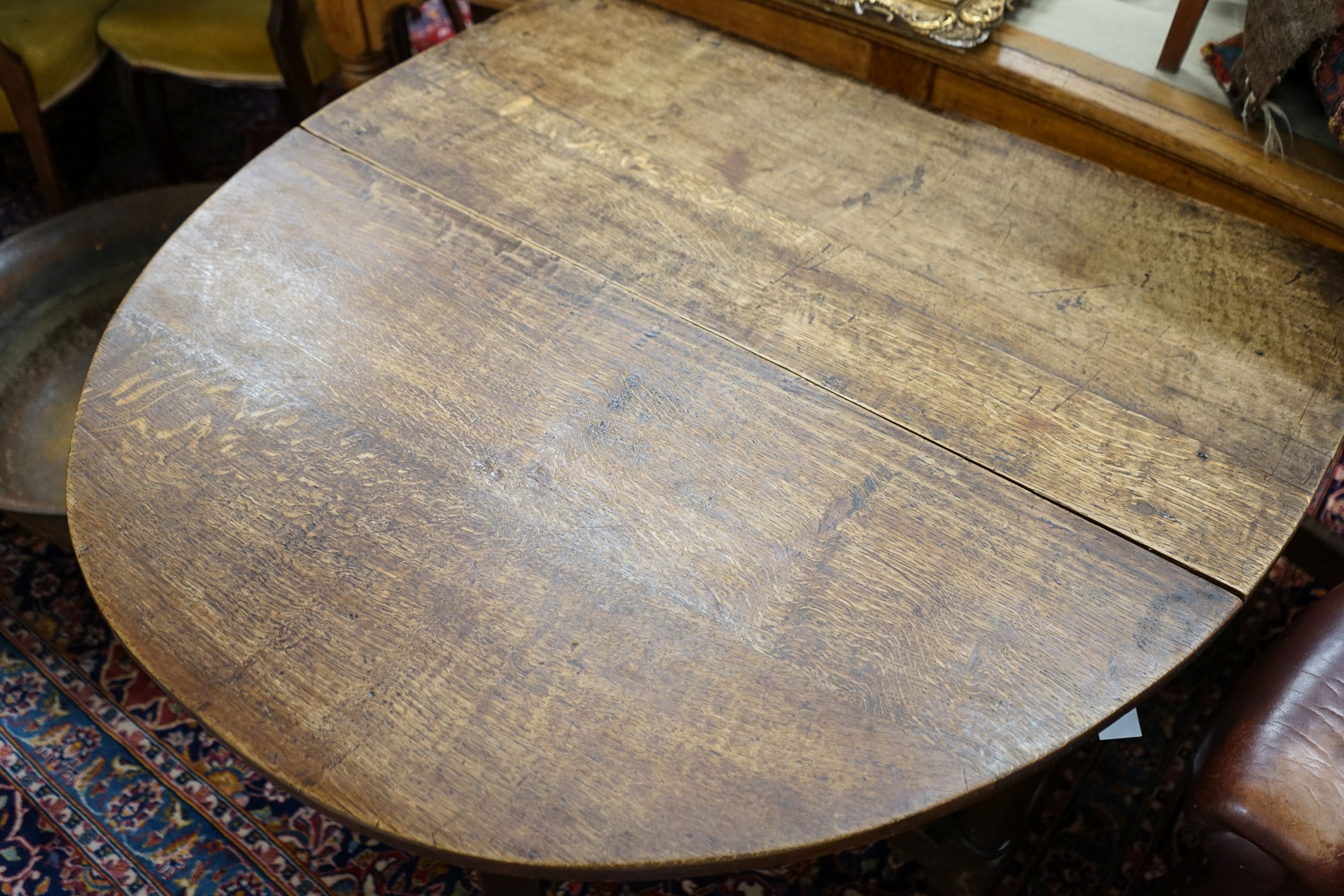 An 18th century style oak gateleg dining table, length 148cm extended, width 105cm, height 76cm